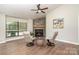 Bright living room features a stone fireplace, high ceilings, and modern decor at 1600 Sharon W Rd # 8, Charlotte, NC 28210