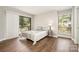 Main bedroom featuring vinyl floors, sliding glass door and balcony access, and a side table at 1600 Sharon W Rd # 8, Charlotte, NC 28210
