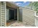 View of the wooden patio with access door and sliding glass door to the residence at 1600 Sharon W Rd # 8, Charlotte, NC 28210