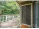 A welcoming entryway featuring a 'Stay awhile' doormat and a dark colored painted door at 1600 Sharon W Rd # 8, Charlotte, NC 28210