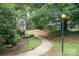 A charming walkway meanders through lush greenery, accented by a vintage lamppost at 1600 Sharon W Rd # 8, Charlotte, NC 28210