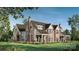 Stunning brick and siding home showcasing a manicured lawn and charming architectural details at 1636 Ferncliff Rd, Charlotte, NC 28211