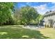 Lovely backyard view with a sparkling in-ground pool and the home's exterior and a large, well-maintained lawn at 16614 Beech Hill Dr, Huntersville, NC 28078