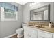 Well-lit bathroom featuring a double vanity, tile backsplash, large mirror, and a toilet at 16614 Beech Hill Dr, Huntersville, NC 28078