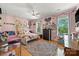 Bright and colorful bedroom featuring hardwood floors, whimsical decorations, and a ceiling fan at 16614 Beech Hill Dr, Huntersville, NC 28078