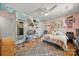 Fun bedroom with hardwood floors, a ceiling fan, stylish decorations, and a sunlit window at 16614 Beech Hill Dr, Huntersville, NC 28078