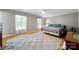 Spacious bedroom featuring wood floors, neutral paint, a ceiling fan, and large windows at 16614 Beech Hill Dr, Huntersville, NC 28078