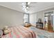 Comfortable bedroom featuring a ceiling fan, closet, area rug, and a sunlit window with curtains at 16614 Beech Hill Dr, Huntersville, NC 28078