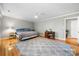Spacious bedroom featuring wood floors, neutral paint, a ceiling fan, and large windows at 16614 Beech Hill Dr, Huntersville, NC 28078