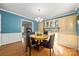 Inviting dining room features wood floors, a decorative light fixture, and a built-in cabinet for storage at 16614 Beech Hill Dr, Huntersville, NC 28078