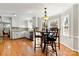 Bright eat-in kitchen with white cabinets, stainless appliances, hardwood floors and a large window to the backyard at 16614 Beech Hill Dr, Huntersville, NC 28078