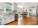 Bright kitchen with white cabinets, stainless dishwasher, hardwood floors and a breakfast table at 16614 Beech Hill Dr, Huntersville, NC 28078