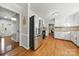 Modern kitchen featuring stainless steel refrigerator, white cabinets, and hardwood floors at 16614 Beech Hill Dr, Huntersville, NC 28078
