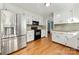 Updated kitchen with stainless steel appliances, white cabinets, and hardwood floors at 16614 Beech Hill Dr, Huntersville, NC 28078