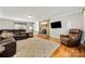 Cozy living room with fireplace, hardwood floors, and comfortable seating at 16614 Beech Hill Dr, Huntersville, NC 28078