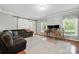 Cozy living room with hardwood floors, sliding barn door, and ample natural light at 16614 Beech Hill Dr, Huntersville, NC 28078