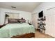 A cozy bedroom with vaulted ceiling, carpeted floor and decor shelving at 1766 Forest Side Ln, Charlotte, NC 28213
