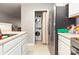 Bright kitchen space with stainless steel appliances, including a utility closet with stacked washer/dryer at 1766 Forest Side Ln, Charlotte, NC 28213