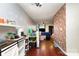 Spacious living area with hardwood floors and brick accent wall at 1766 Forest Side Ln, Charlotte, NC 28213