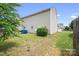 View of a fenced-in backyard with a sliding door entry to the home and two trashcans on a concrete slab at 1849 Meadow Crossing Dr # 118, Huntersville, NC 28078