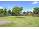 Large fenced-in backyard featuring healthy green grass and a mature tree at 1849 Meadow Crossing Dr # 118, Huntersville, NC 28078