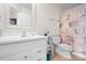 Well-lit bathroom featuring a toilet, sink, mirror and updated fixtures at 1849 Meadow Crossing Dr # 118, Huntersville, NC 28078