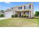 Two-story home with stone accents, a well-maintained lawn, and a welcoming front porch at 1849 Meadow Crossing Dr # 118, Huntersville, NC 28078