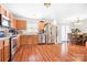 Well-lit kitchen with stainless steel appliances, wood cabinets, and an adjacent dining area at 1849 Meadow Crossing Dr # 118, Huntersville, NC 28078