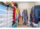 Well-organized walk-in closet with shelves and hanging rods for efficient storage of clothes and accessories at 1849 Meadow Crossing Dr # 118, Huntersville, NC 28078