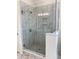 Modern bathroom featuring a glass-enclosed shower with marble tile and a built-in niche at 19044 Newburg Hill Rd, Davidson, NC 28036