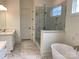 Luxurious bathroom with a soaking tub, glass-enclosed shower, and double vanity at 19044 Newburg Hill Rd, Davidson, NC 28036