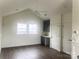Bonus room with high ceiling features a kitchenette and beautiful dark wood floors at 19044 Newburg Hill Rd, Davidson, NC 28036