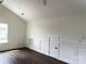 Bright bonus room featuring dark wood floors, wainscoting, a high ceiling and great natural light at 19044 Newburg Hill Rd, Davidson, NC 28036