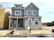 Charming two-story home with a brick foundation, gray siding, and a welcoming covered front porch at 19044 Newburg Hill Rd, Davidson, NC 28036