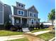Charming gray two-story home with white trim, manicured lawn and inviting front porch and tasteful landscaping at 19044 Newburg Hill Rd, Davidson, NC 28036