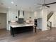 Modern kitchen boasts an island, stainless steel appliances, and custom cabinetry at 19044 Newburg Hill Rd, Davidson, NC 28036