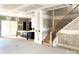 Unfinished kitchen area with a staircase, large island, and sliding glass door for an open and inviting space at 19044 Newburg Hill Rd, Davidson, NC 28036