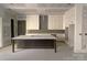 Unfinished kitchen featuring a large center island, elegant white cabinets, and a modern design for customized culinary experiences at 19044 Newburg Hill Rd, Davidson, NC 28036