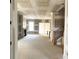 Unfinished living room featuring a fireplace, large windows, and an open-concept layout ready for customization at 19044 Newburg Hill Rd, Davidson, NC 28036