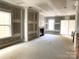 Spacious unfinished living room featuring a fireplace, large windows, and an open layout ready for personalization at 19044 Newburg Hill Rd, Davidson, NC 28036