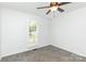 This empty bedroom features neutral carpet, white walls, ceiling fan and a window with light coming through at 2068 Samantha Dr, Kannapolis, NC 28083