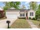 Charming single-story home featuring a well-maintained lawn and an attached two-car garage at 2068 Samantha Dr, Kannapolis, NC 28083