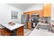 Bright eat-in kitchen equipped with stainless steel appliances, white countertops and wooden cabinets at 2068 Samantha Dr, Kannapolis, NC 28083