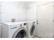 The laundry room features a full size washer and dryer, and a white painted entry door at 2068 Samantha Dr, Kannapolis, NC 28083