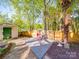 Backyard featuring a shed, hammock, stone pathway, and landscaping, offering a private and relaxing outdoor retreat at 215 6Th St, Belmont, NC 28012