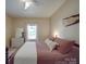 Comfortable bedroom featuring a queen-sized bed, ceiling fan, and neutral color scheme at 215 6Th St, Belmont, NC 28012