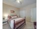 Cozy bedroom featuring a queen-sized bed, large windows, and a ceiling fan at 215 6Th St, Belmont, NC 28012