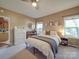 Cozy bedroom featuring a queen-sized bed, large windows, and a ceiling fan at 215 6Th St, Belmont, NC 28012