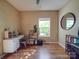 Bright bedroom features a white desk, a round mirror, and ample natural light from the window at 215 6Th St, Belmont, NC 28012