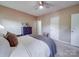 Comfortable bedroom featuring a queen-sized bed, ceiling fan, and neutral color scheme at 215 6Th St, Belmont, NC 28012